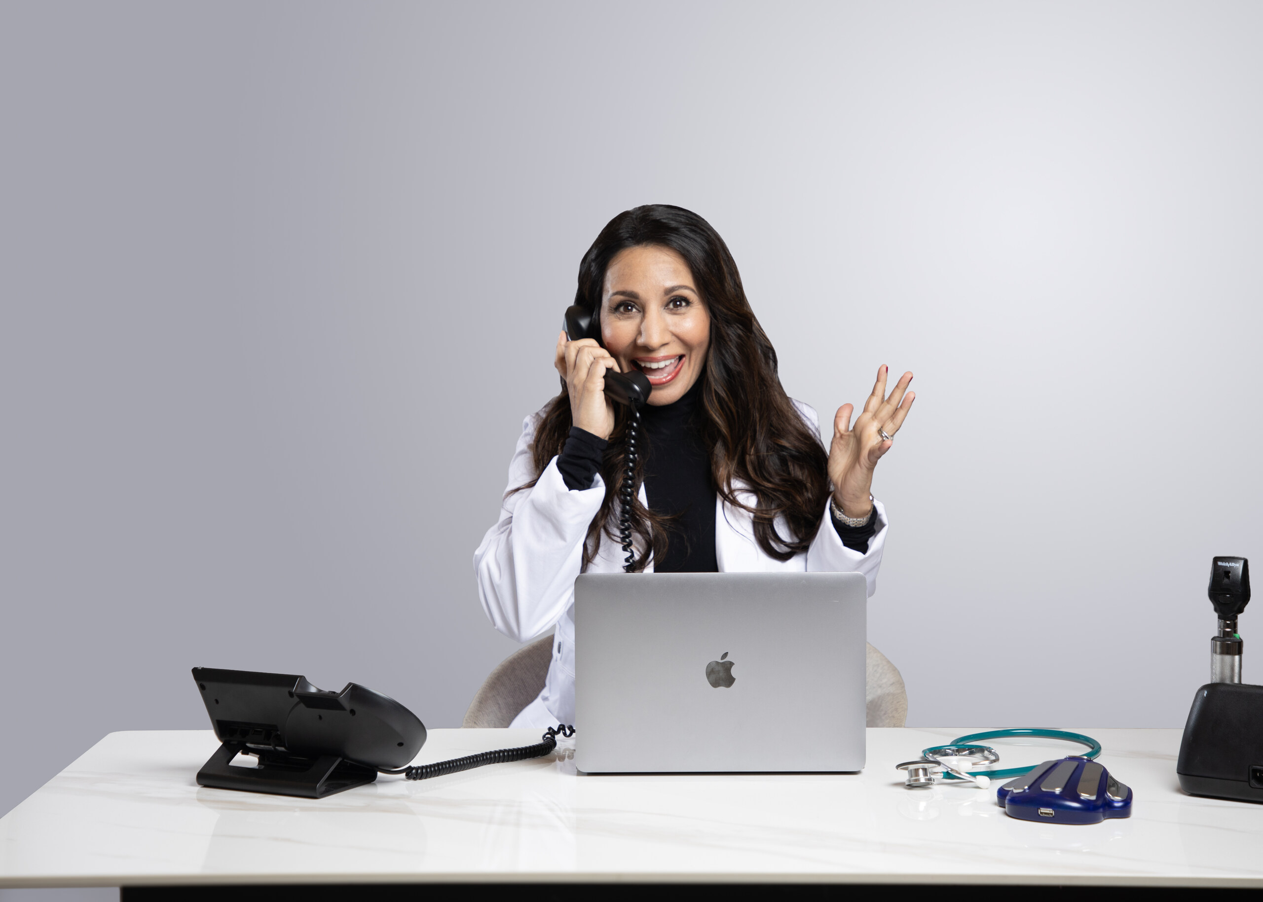 Dr. Taz MD taking a call at her desk