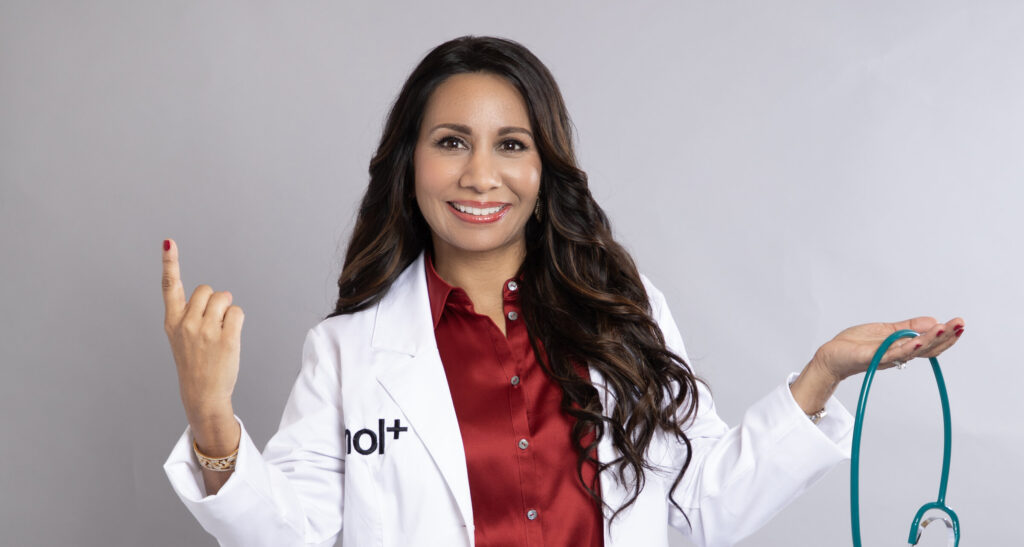 Dr. Taz MD in her hol+ coat holding a stethoscope